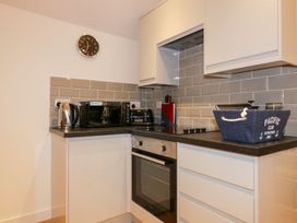 A kitchen with appliances and storage at Fishermans Loft in Mevagissey