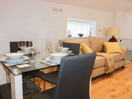 A living room with a dining table and sofa at Fishermans Loft in Mevagissey