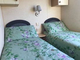 A bedroom with two single beds at Beautifully Presented 2 Bedroom Static Caravan, Monreith near Whithorn