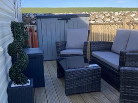 An outdoor seating area with a sofa and table at Beautifully Presented 2 Bedroom Static Caravan in Monreith near Whithorn