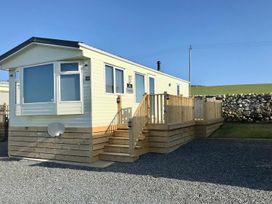 A static caravan with steps and decking at Beautifully Presented 2 Bedroom Static Caravan, Monreith near Whithorn