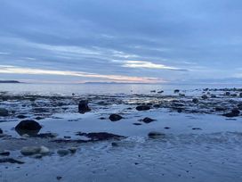 A beach with rocks and water at Beautifully Presented 2 Bedroom Static Caravan Monreith near Whithorn