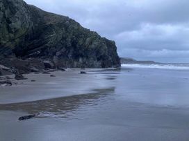 A rocky shoreline with waves at a beach