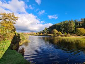 A scenic view of a lake surrounded by trees at Beautifully Presented 2 Bedroom Static Caravan Monreith near Whithorn