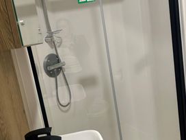 A bathroom with a shower and toilet at 