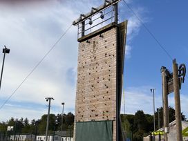 A climbing wall with safety equipment in an outdoor area