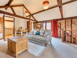 A living room with a sofa and coffee table at Barn Conversion Sleeps 2 with Parking in Diss