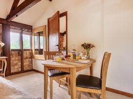 A dining area with a table set for breakfast at Barn Conversion Sleeps 2 with Parking in Diss