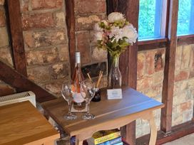 A table with wine, glasses and flowers at Barn Conversion Sleeps 2 with Parking in Diss