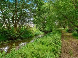 A stream surrounded by trees and a path at Barn Conversion Sleeps 2 with Parking in Diss