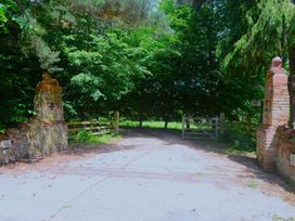 An outdoor entrance with brick gate posts and a pathway at Elm Farm