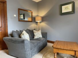 A living room with a sofa, lamp, and coffee table at Milecastle Inn on Hadrian's Wall near Haltwhistle
