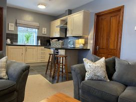 A kitchen area with bar stools and couches at Milecastle Inn on Hadrian's Wall near Haltwhistle
