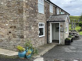 An entrance with window and flowers at Milecastle Inn on Hadrian's Wall near Haltwhistle