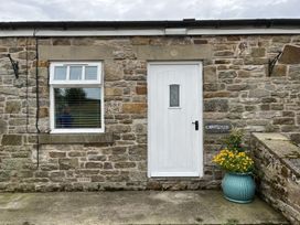 An outdoor area with a door and a flower pot at Cawfields near Haltwhistle