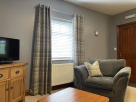 A living room with a tv and a sofa at Milecastle Inn on Hadrian's Wall near Haltwhistle