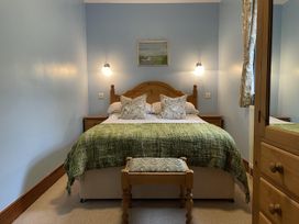 A bedroom with a bed and bedside table at Milecastle Inn on Hadrian's Wall near Haltwhistle