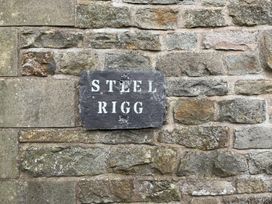 A nameplate saying STEEL RIGG on a stone wall at Milecastle Inn on Hadrian's Wall near Haltwhistle