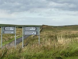 A directional sign on a road in a field near Milecastle Inn on Hadrian's Wall near Haltwhistle