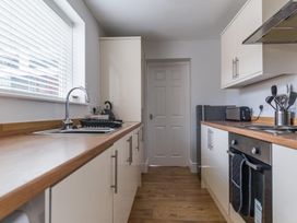 A kitchen with a sink and appliances at East House-Sleeps 5-Pet friendly-Garden-Parking in Stakeford