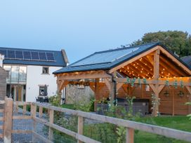 An outdoor area with a house and shelter featuring solar panels at Northumberland Luxury Stays - The Chivits West Chevington near Amble
