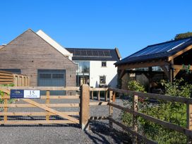 A house with solar panels and a gated entrance at Northumberland Luxury Stays - The Chivits West Chevington near Amble