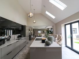 A kitchen with an island and chairs at Northumberland Luxury Stays - The Chivits, West Chevington near Amble