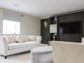 A living room with a sofa and television at Northumberland Luxury Stays - The Chivits near West Chevington