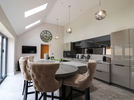 A kitchen with a table and chairs at Northumberland Luxury Stays - The Chivits near West Chevington