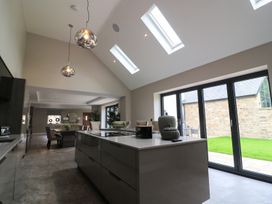 A kitchen with a central island and dining area at Northumberland Luxury Stays - The Chivits near West Chevington