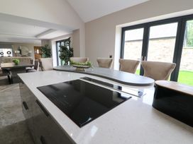 A kitchen with a cooktop and dining area at Northumberland Luxury Stays - The Chivits West Chevington near Amble