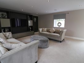 A living room with sofa and television at Northumberland Luxury Stays - The Chivits near Amble