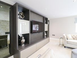 A living room with a television and decorative objects at Northumberland Luxury Stays - The Chivits near Amble