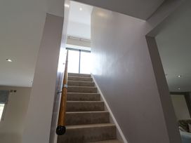 A staircase with a handrail and a window at Northumberland Luxury Stays - The Chivits near West Chevington