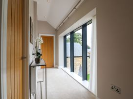 A hallway with a door and window at Northumberland Luxury Stays - The Chivits near Amble