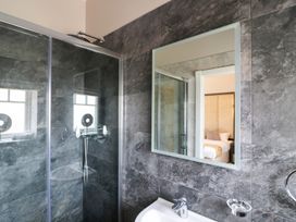 A bathroom with a shower and mirror at Northumberland Luxury Stays - The Chivits near Amble