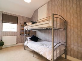 A bedroom with a bunk bed and window at Northumberland Luxury Stays - The Chivits near West Chevington