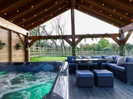 An outdoor space with a hot tub and seating area at Northumberland Luxury Stays - The Chivits in West Chevington near Amble