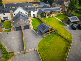 An outdoor area with houses, gardens, and solar panels at Northumberland Luxury Stays - The Chivits, West Chevington near Amble