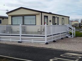 A mobile home with decking and railing at Port Haverigg Cabin Sleeps 4 Steel Green near Haverigg