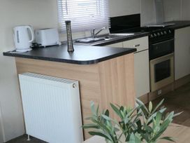 A kitchen with a stove and sink at Port Haverigg Cabin Sleeps 4 Steel Green near Haverigg