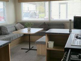 A living room with a sofa and table at Port Haverigg Cabin Sleeps 4 Steel Green near Haverigg