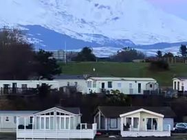 View of mobile homes with a snow-capped mountain in the background at Port Haverigg Cabin Sleeps 4 Steel Green near Haverigg