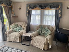 A living room with two chairs and a small table at 2 Bed Lodge Sleeps 5 - Pet Friendly, WiFi, Parking in Skegness