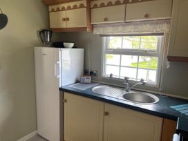 A kitchen with a refrigerator and sink at 2 Bed Lodge Sleeps 5 - Pet Friendly, WiFi, Parking Skegness