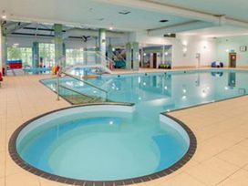 A swimming pool area with a hot tub and a ladder at 2 Bed Lodge Sleeps 5 - Pet Friendly, WiFi, Parking Skegness