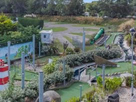 An outdoor mini golf course with landscaping and playground features at 2 Bed Lodge Sleeps 5 - Pet Friendly, WiFi, Parking in Skegness