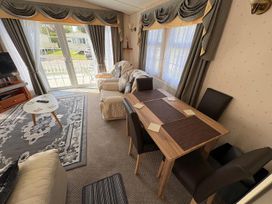 A living room with a dining table and sofa at 2 Bed Lodge Sleeps 5 - Pet Friendly, WiFi, Parking in Skegness