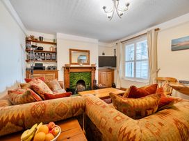 A living room with a fireplace and sofa at 1 Bed - Sleeps 4 - Parking - Pets - Town Centre in Wadebridge