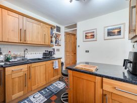 A kitchen with wooden cabinets and a countertop at 1 Bed - Sleeps 4 - Parking - Pets - Town Centre, Wadebridge